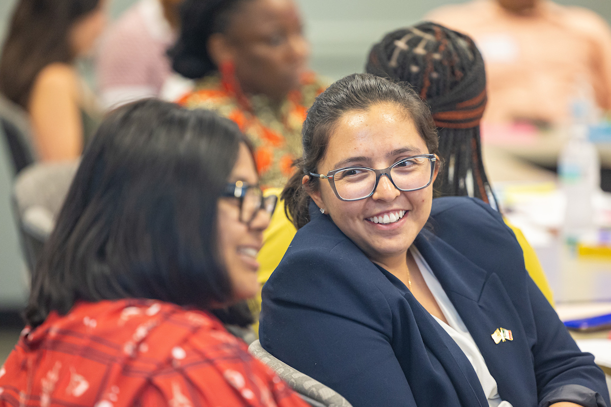 Two women laughing at LGBTQ+ youth round table event